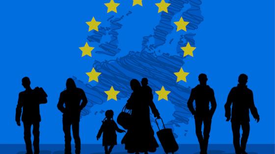 Men, women and children in front of EU flag