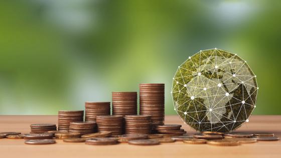 Green globe and stacks of coins