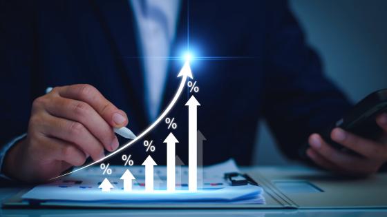 Businessman with percentage symbols and upwards arrows