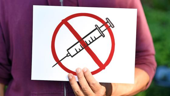 Man holding anti-vaccine sign