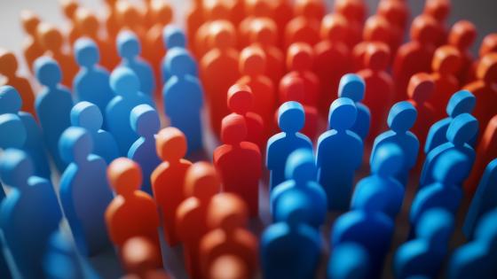 Crowd of figures painted either red or blue